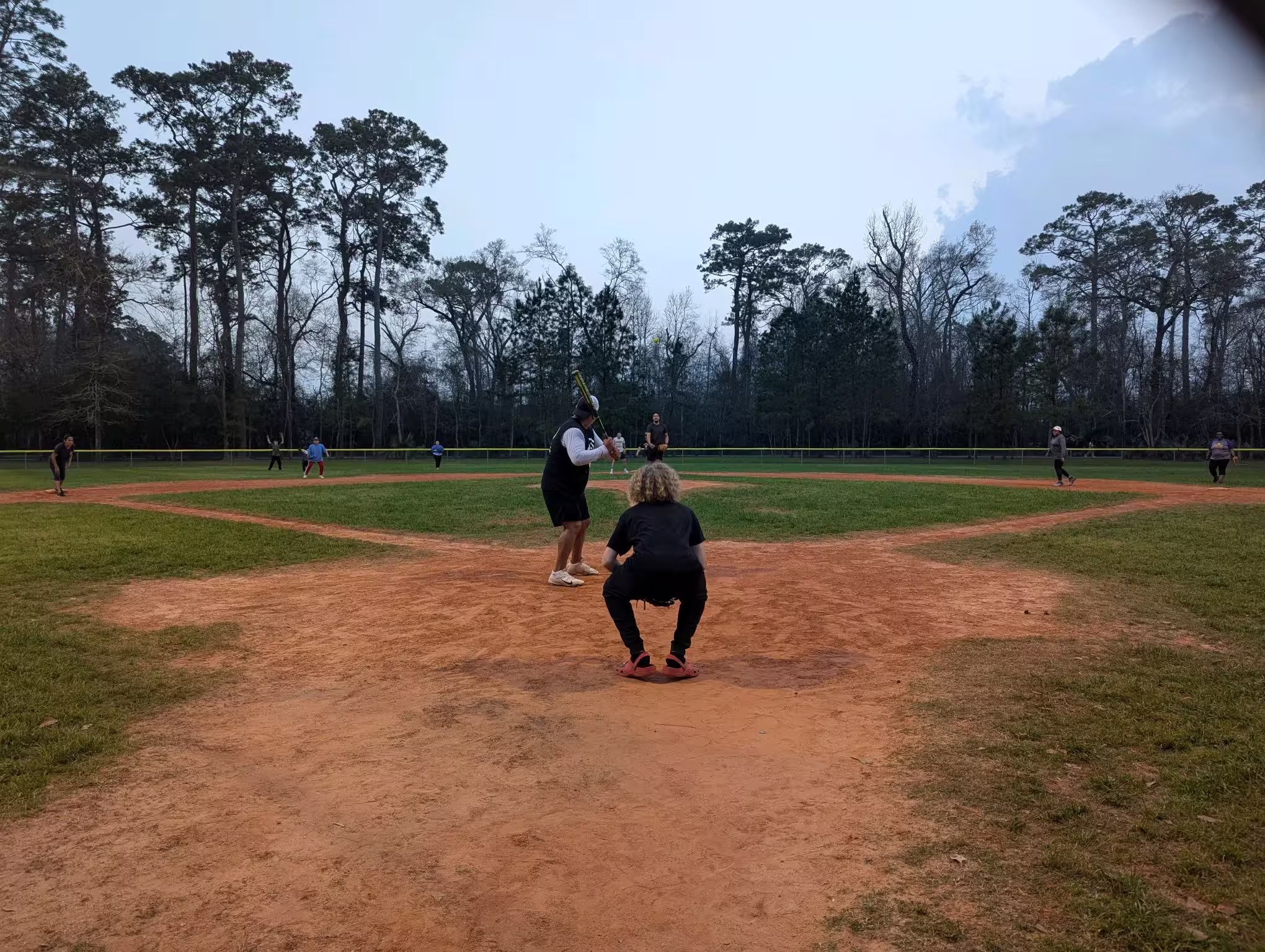 Nice view of the field with a member about to bat and another pitching.