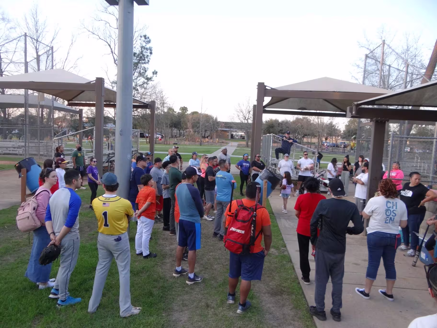 Several people gathered in a circle, listening to Alexis going over the lesson